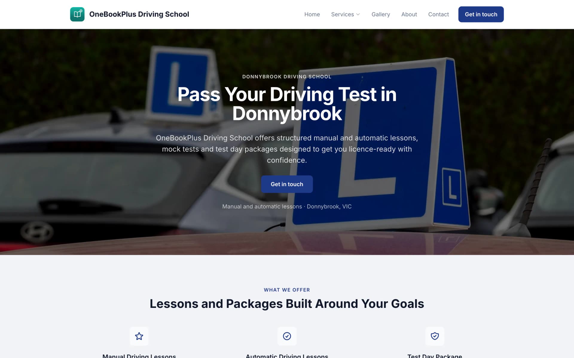 The OneBookPlus Driving School home page on a desktop: the teal logo and name on the left, the menu and a navy Get in touch button on the right, a hero photo of learner L plates on car roofs under the heading Pass Your Driving Test in Donnybrook, and the top of the Lessons and Packages grid