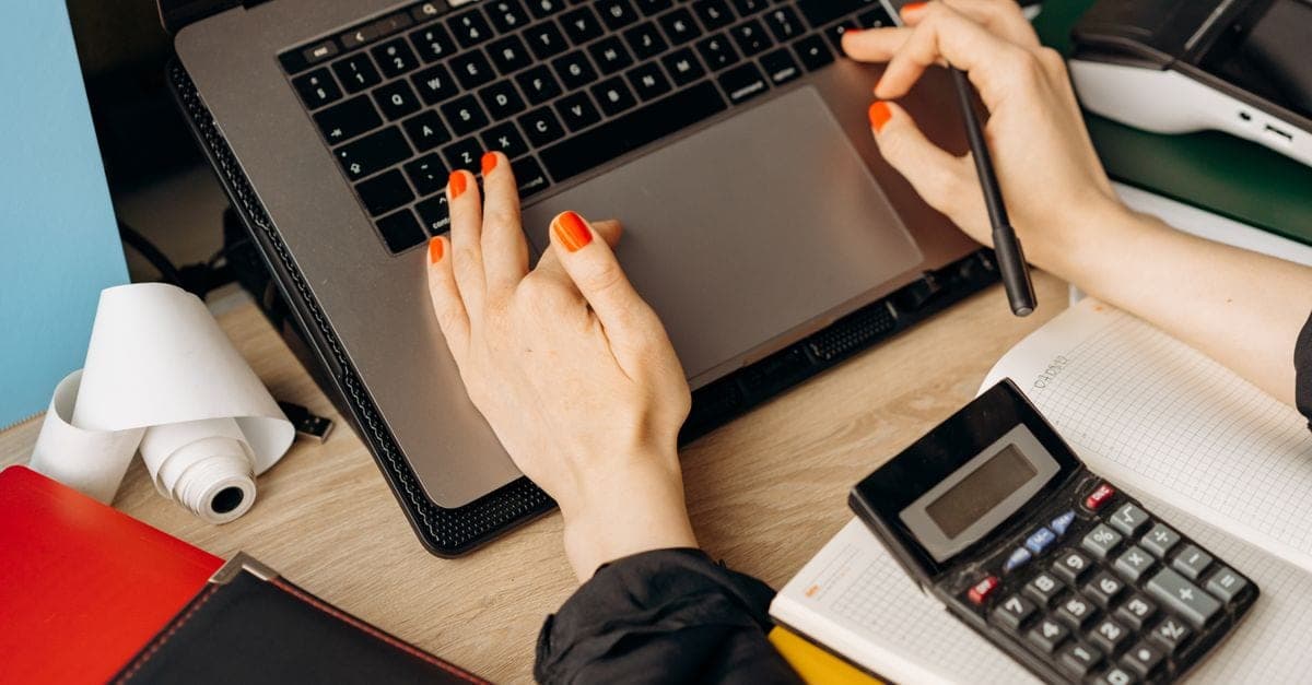 Bookkeeper reconciling financial accounts on a computer