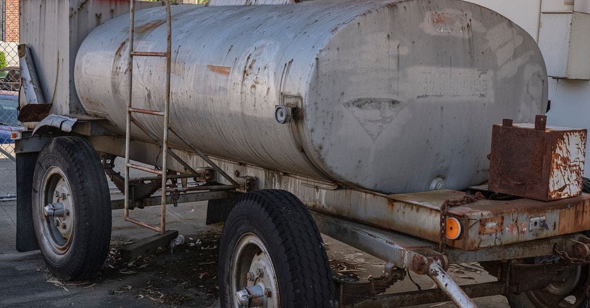 Old rusted hot water tank removed from property