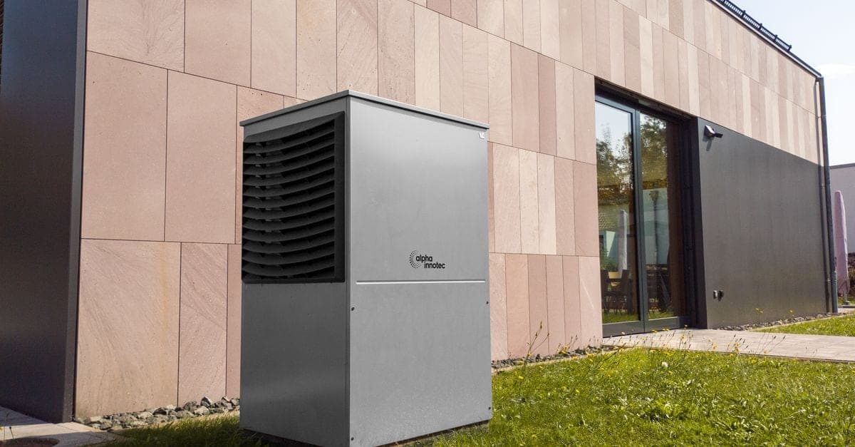Heat pump hot water system installed in a suburban backyard