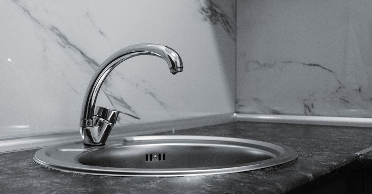 Tap replacement — modern mixer tap fitted to a kitchen sink in a Sydney terrace house